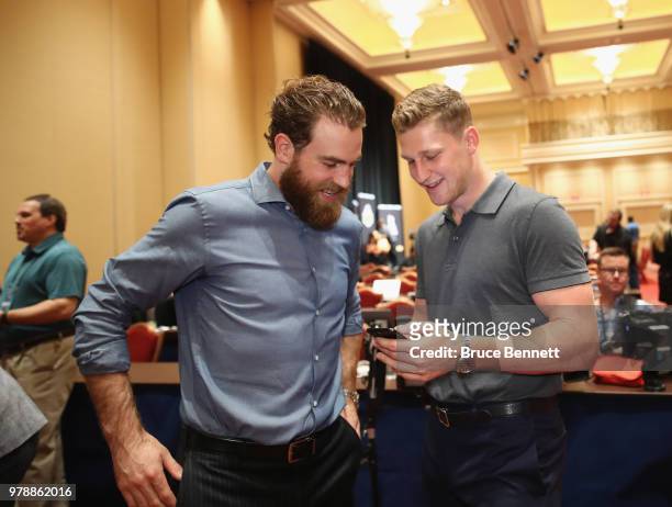 Ryan O'Reilly and Nathan MacKinnon share a laugh during the 2018 NHL Awards nominee media availability at the Encore Las Vegas on June 19, 2018 in...