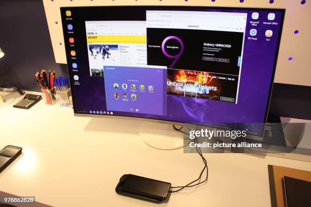 February 2018, England, London: The new Samsung Galaxy S9 is connected to a computer - it can be used with a desktop computer, with a mouse and...