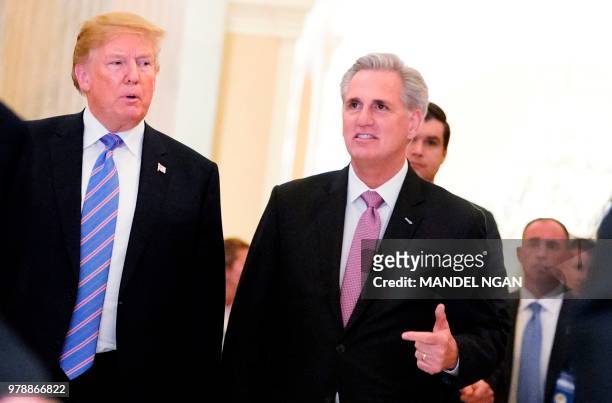 President Donald Trump walks next to US House Majority Leader Kevin McCarthy after a meeting at the US Capitol with the House Republican Conference...