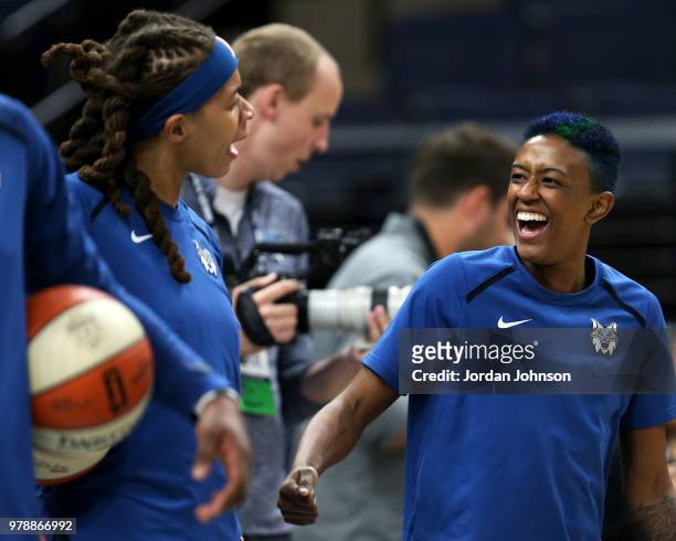 Danielle Robinson shares a laugh with Seimone Augustus of the Minnesota Lynx before the game against the Dallas Wings on June 19, 2018 at Target...