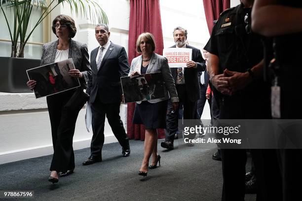Rep. Lucille Roybal-Allard , Rep. Adriano Espaillat , Rep. Michelle Lujan Grisham , Rep. Juan Vargas hold signs as they stage a protest outside a...