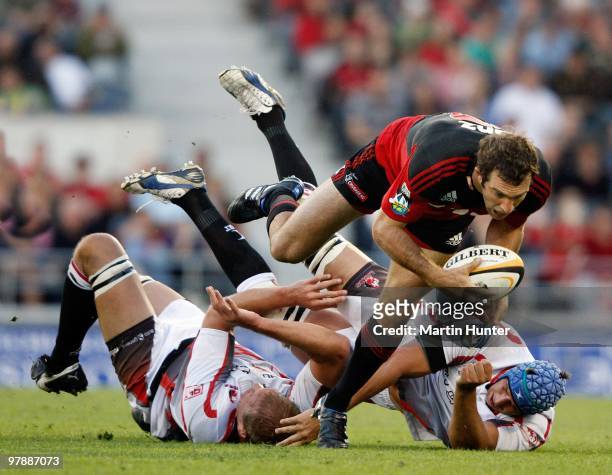 Adam Whitelock of the Crusaders is tackled by Jacques Lombaard and Willem Stoltz of the Lions during the round six Super 14 match between the...