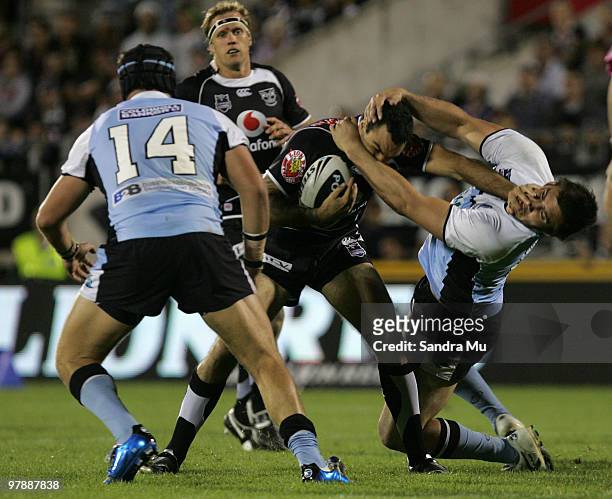 Wade McKinnon of the Warriors fends off Blake Ferguson of the Sharks during the round two NRL match between the Warriors and the Cronulla Sharks at...