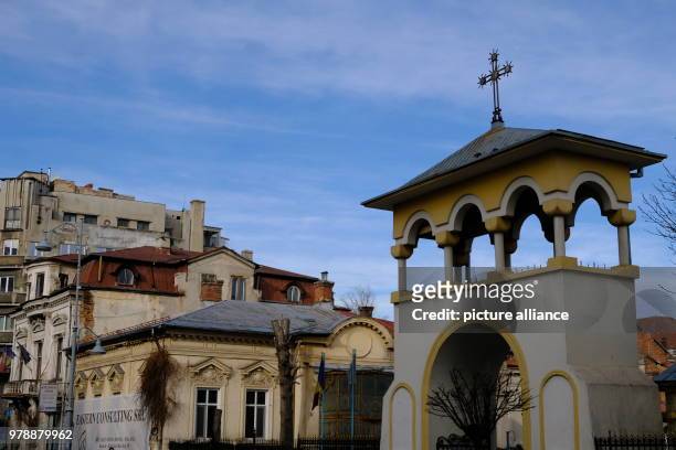 January 2018, Romania, Bukarest: The tower of a well-renovated church next to houses from different building periods. Photo: Birgit...