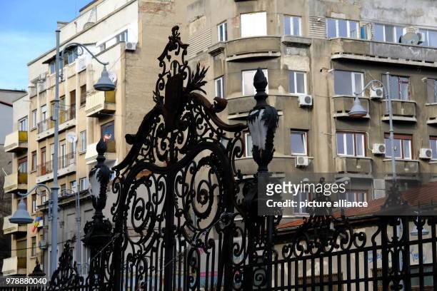 January 2018, Romania, Bukarest: A splendig iron gate in front of a art nouveau Palais. A grey apartment building seen in the background. Photo:...
