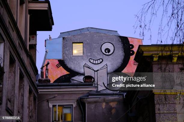 January 2018, Romania, Bukarest: A picture of the street art artist Pisica Patrata seen on a facade in the evening. Photo: Birgit...