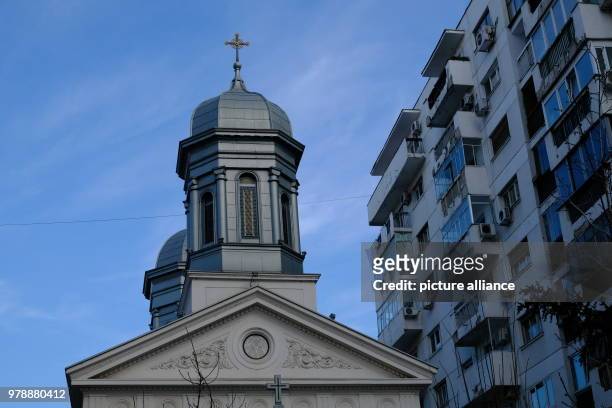January 2018, Romania, Bukarest: A church tower next to an apartment block. Photo: Birgit Zimmermann/dpa-Zentralbild/dpa
