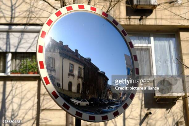 January 2018, Romania, Bukarest: Old and new often lie next to each other in Bukarest as seen in this traffic mirror. Photo: Birgit...