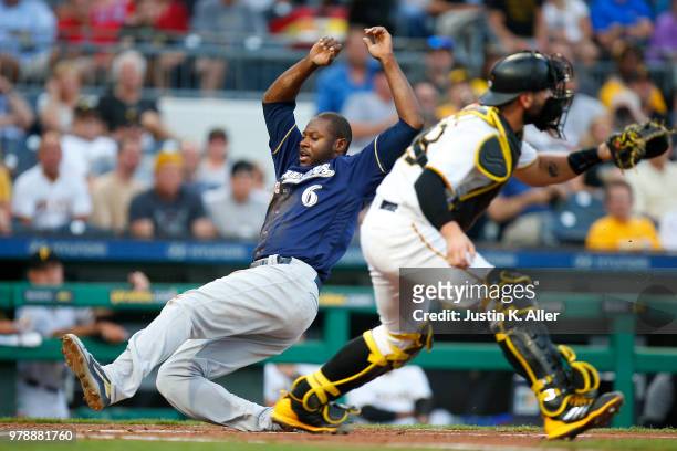 Lorenzo Cain of the Milwaukee Brewers scores on an RBI double in the third inning against Francisco Cervelli of the Pittsburgh Pirates at PNC Park on...