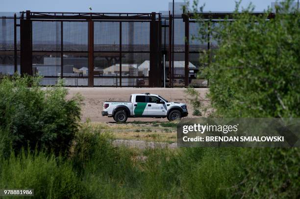 Border Patrol agent patrols the bed of the Rio Grand in front of where the US Customs and Boarder Protection is housing underage people caught...