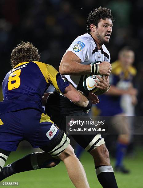 Ryan Kankowski of the Sharks is tackled by Adam Thomson of the Highlanders during the round six Super 14 match between the Highlanders and the Sharks...