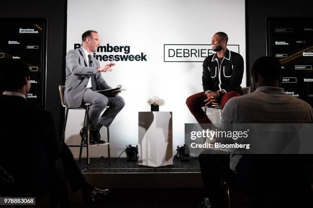 Dwyane Wade, a professional basketball player with the National Basketball Association's Miami Heat, right, smiles during a Bloomberg Businessweek...