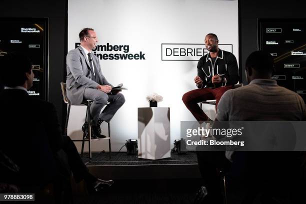 Dwyane Wade, a professional basketball player with the National Basketball Association's Miami Heat, right, speaks during a Bloomberg Businessweek...