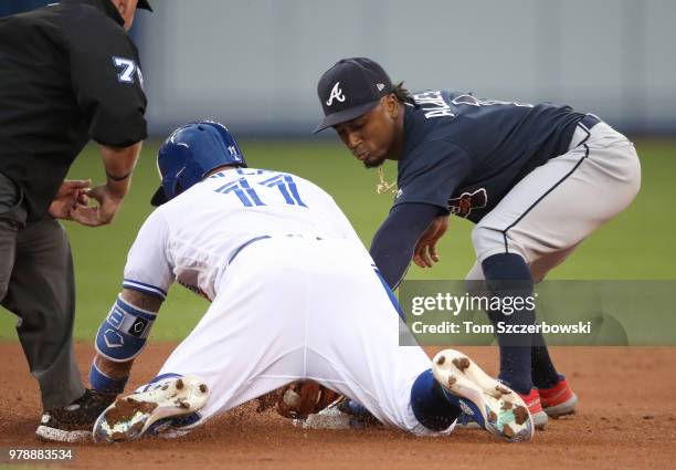 Kevin Pillar of the Toronto Blue Jays slides safely into second base with a double in the fourth inning during MLB game action as Ozzie Albies of the...