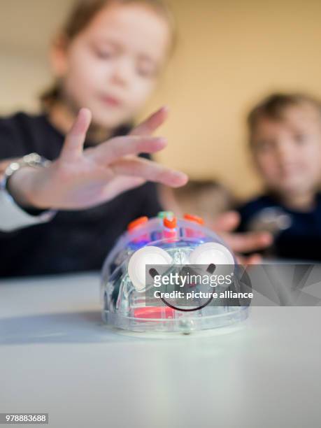 February 2018, Germany, Duesseldorf: Children at the nursery 'Seepferdchen' learn coding in a playful way. The children move a digital bug with...