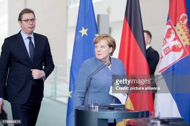 German Chancellor Angela Merkel and Serbian President Aleksandar Vucic arrive for a joint press conference following their meeting at the Chancellery...