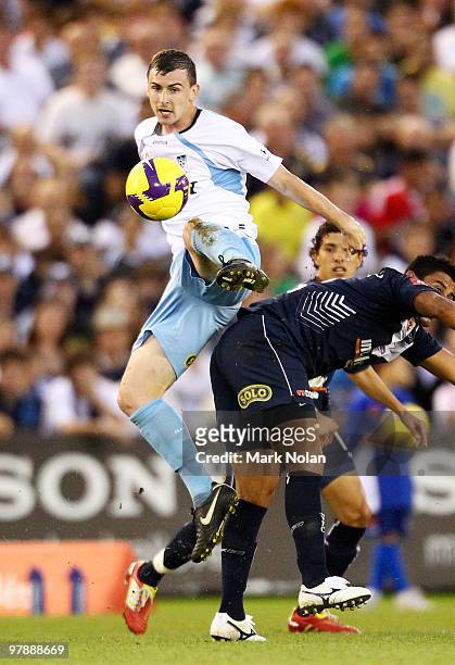 Sebastian Ryall of Sydney and Carlos Hernandez of Melbourne contest possession during the A-League Grand Final match between the Melbourne Victory...