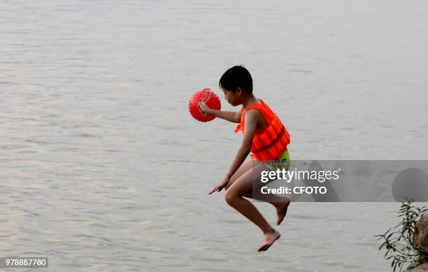 On June 19 residents in the upper reaches of the pearl river, rongjiang county, liuzhou city, guangxi province, China,played in the middle of the...