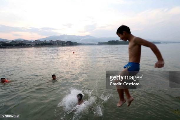 On June 19 residents in the upper reaches of the pearl river, rongjiang county, liuzhou city, guangxi province, China,played in the middle of the...