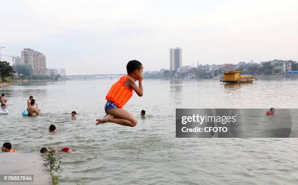 On June 19 residents in the upper reaches of the pearl river, rongjiang county, liuzhou city, guangxi province, China,played in the middle of the...