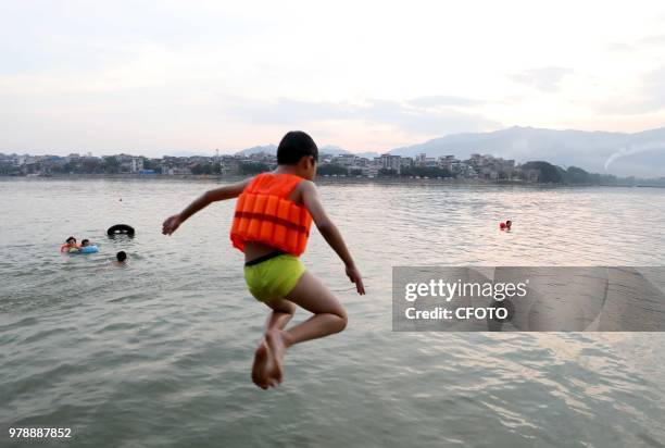 On June 19 residents in the upper reaches of the pearl river, rongjiang county, liuzhou city, guangxi province, China,played in the middle of the...