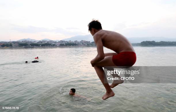 On June 19 residents in the upper reaches of the pearl river, rongjiang county, liuzhou city, guangxi province, China,played in the middle of the...