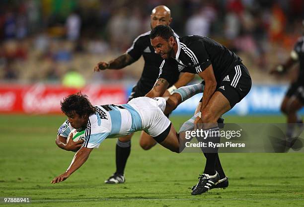 Tomas Passerotti of Argentina is tackled by Zar Lawrence of New Zealand during the match between New Zealand and Argentina during day two of the IRB...