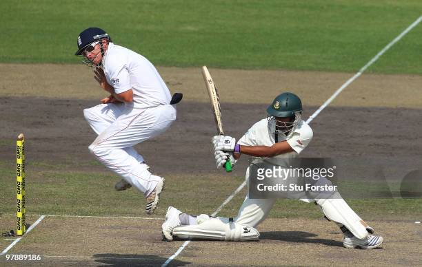 Bangladesh batsman Shakib Al Hasan hits out as England fielder Ian Bell jumps out of the way during day one of the 2nd Test match between Bangladesh...