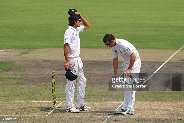 England captain Alastair Cook rubs his head as bowler Graeme Swann marks his run up during day one of the 2nd Test match between Bangladesh and...