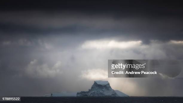 large icebergs under a cloudy and dark sky - south orkney island stock pictures, royalty-free photos & images