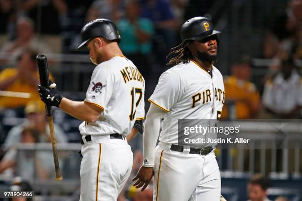 Josh Bell of the Pittsburgh Pirates celebrates after scoring on an RBI double in the seventh inning against the Milwaukee Brewers at PNC Park on June...