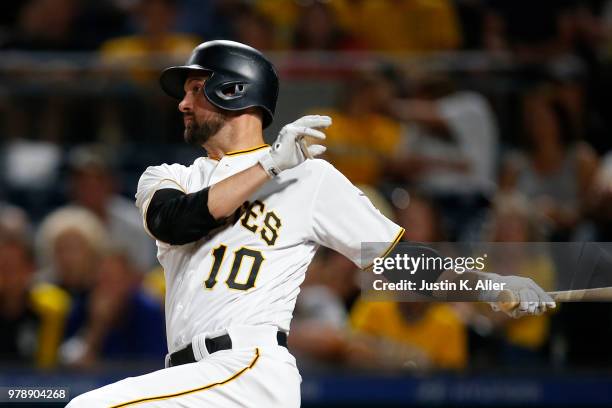 Jordy Mercer of the Pittsburgh Pirates hits an RBI double in the seventh inning against the Milwaukee Brewers at PNC Park on June 19, 2018 in...