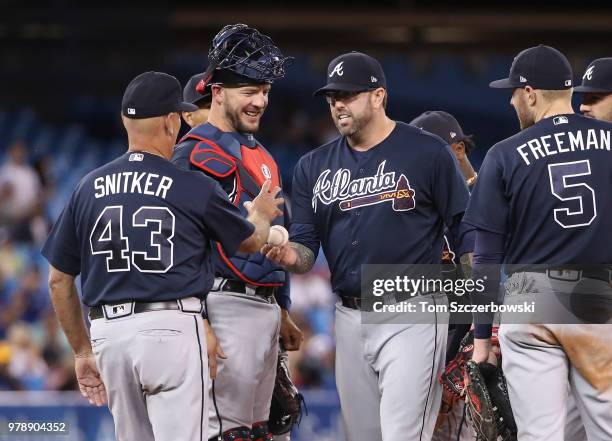 Peter Moylan of the Atlanta Braves exits the game as he is relieved by manager Brian Snitker in the sixth inning during MLB game action against the...