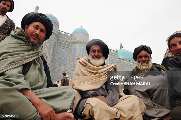 Elderly Afghan men sit by the Hazrat-i Ali shrine in Mazar-i-Sharif, the centre of Afghan New Year's or Nauruz celebrations, on March 20, 2010. The...