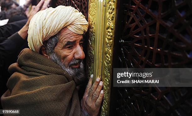 An elderly Afghan man prays inside the Hazrat-i Ali shrine in Mazar-i-Sharif, the centre of Afghan New Year's or Nauruz celebrations, on March 20,...