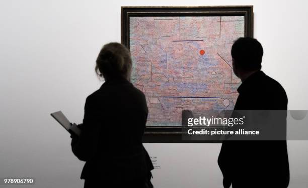 Journalists look at the artwork 'Das Licht und Etliches' by artist Paul Klee during a press preview at the exhibition 'Paul Klee. Konstruktion des...