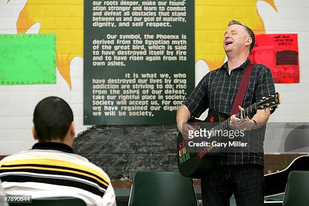 Musician Billy Bragg speaks to students at the Phoenix Academy Of Austin as part of the "Jail Guitar Doors" program during the South By Southwest...