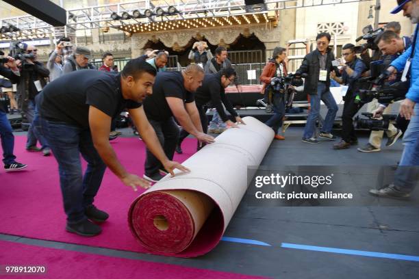 Workers rolling out the red carpet in front of the Dolby theatre in Los Angeles, US, 26 February 2018. The Oscar Awards take place there on 04 March...