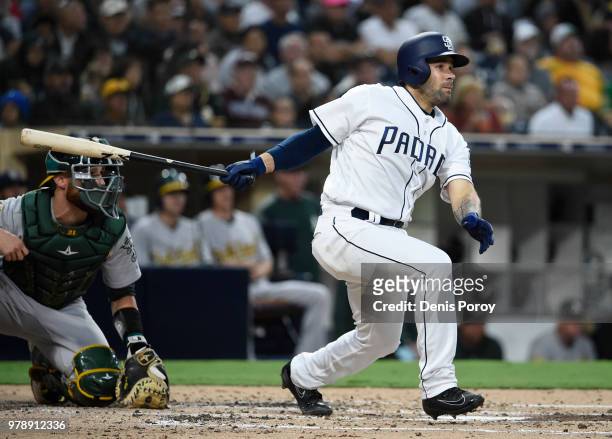 Raffy Lopez of the San Diego Padres hits an RBI single during the second inning of a baseball game against the Oakland Athletics at PETCO Park on...