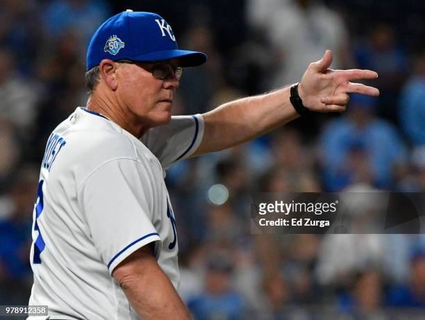 Ned Yost manager of the Kansas City Royals signals for a pitching change in the sixth inning against the Texas Rangers at Kauffman Stadium on June...