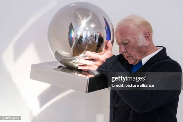 Dpatop - 01 March 2018, Germany, Duesseldorf: ZERO artist Heinz Mack holding the stainless steel ball of his art piece "La Lune en Rodage". Mack came...