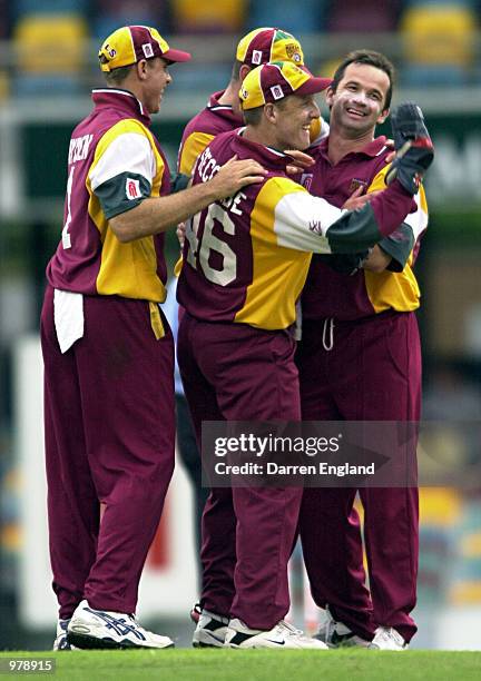 Adam Dale celebrates with team mates after getting the wicket of Matthew Elliott of Victoria who was stumped by Wade Seccombe of Queensland for 107...