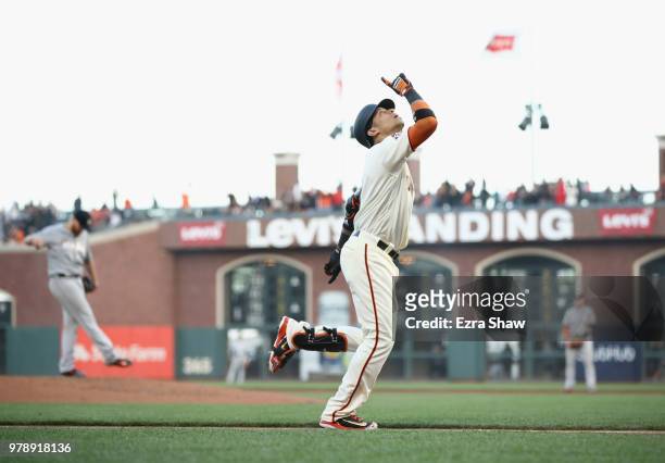 Gorkys Hernandez of the San Francisco Giants points to the sky as he rounds the bases after he hit a home run off of Dan Straily of the Miami Marlins...