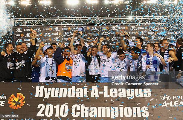 Sydney FC players celebrate with the trophy after winning the A-League Grand Final match between the Melbourne Victory and Sydney FC at Etihad...