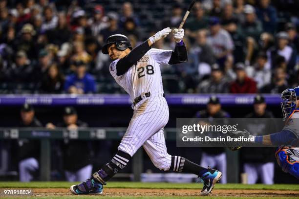 Nolan Arenado of the Colorado Rockies hits a third inning two-run homerun off of Jason Vargas of the New York Mets at Coors Field on June 19, 2018 in...