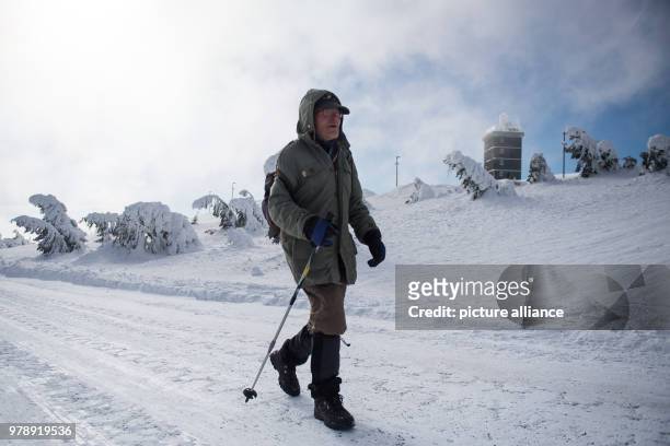 March 2018, Germany, Schierke: Benno Schmidt from Wernigerode, also known as "Brocken-Benno", hiking on the Brockenstrasse in the direcction of the...
