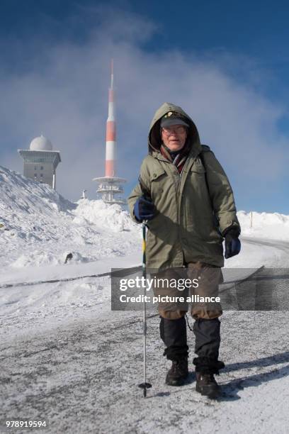 March 2018, Germany, Schierke: Benno Schmidt from Wernigerode, also known as "Brocken-Benno", hiking on the Brockenstrasse in the direcction of the...