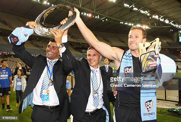 John Aloisi, Steve Corica, and Clint Bolton of Sydney FC hold the trophy aloft after winning the A-League Grand Final match between the Melbourne...