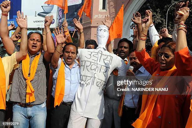 Vishwa Hindu Parishad demonstrators, accompanied by Bajrang Dal activists, shout slogans as they prepare to burn an effigy representing the Orissa...