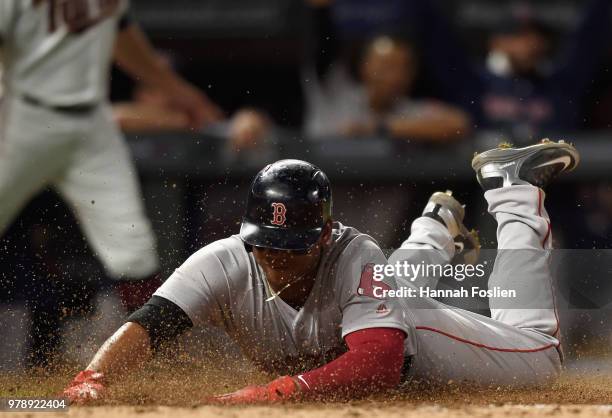 Rafael Devers of the Boston Red Sox slides safely into home plate to score a run against the Minnesota Twins during the eighth inning of the game on...